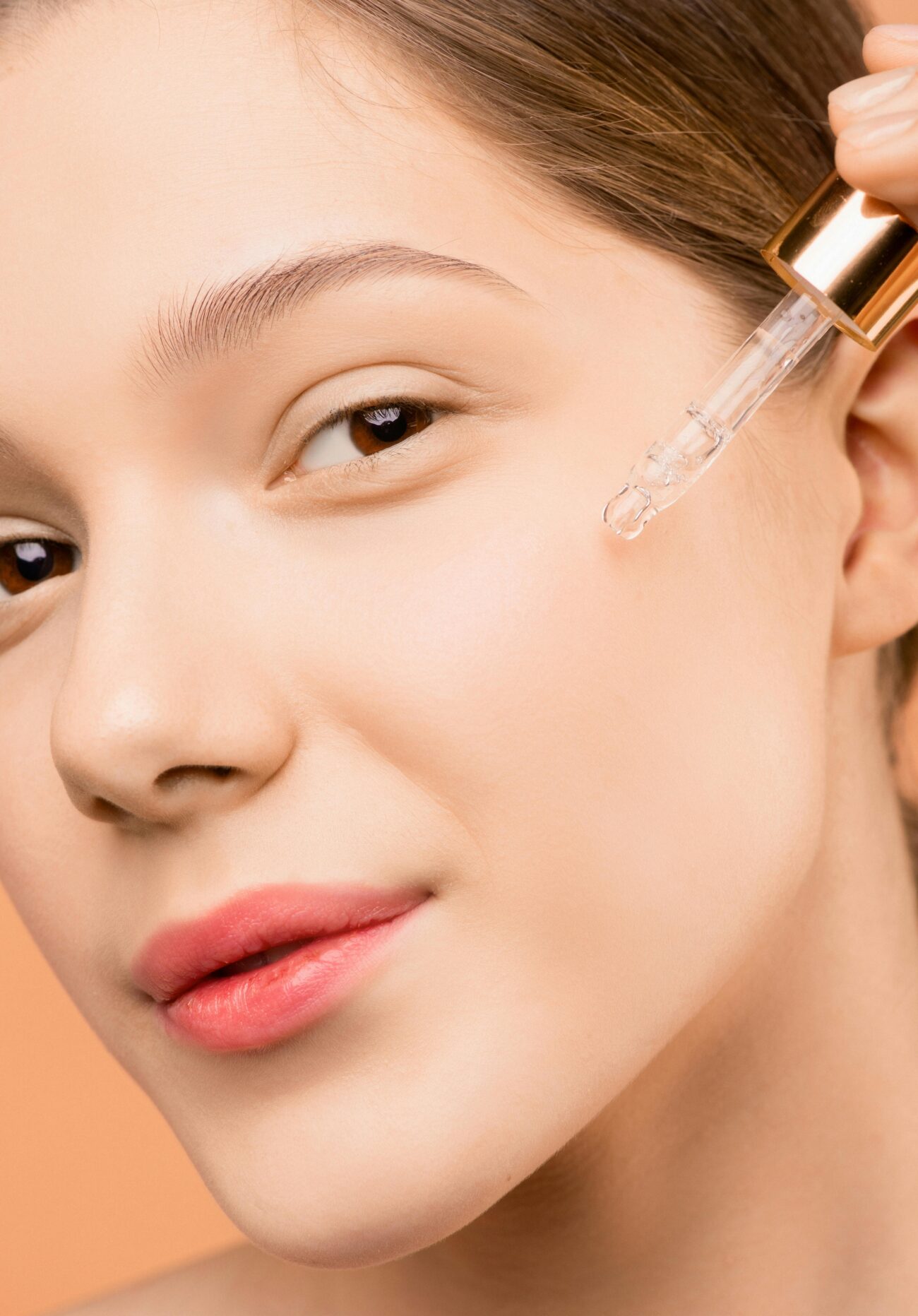 a girl is applying Vanilla Oil on face