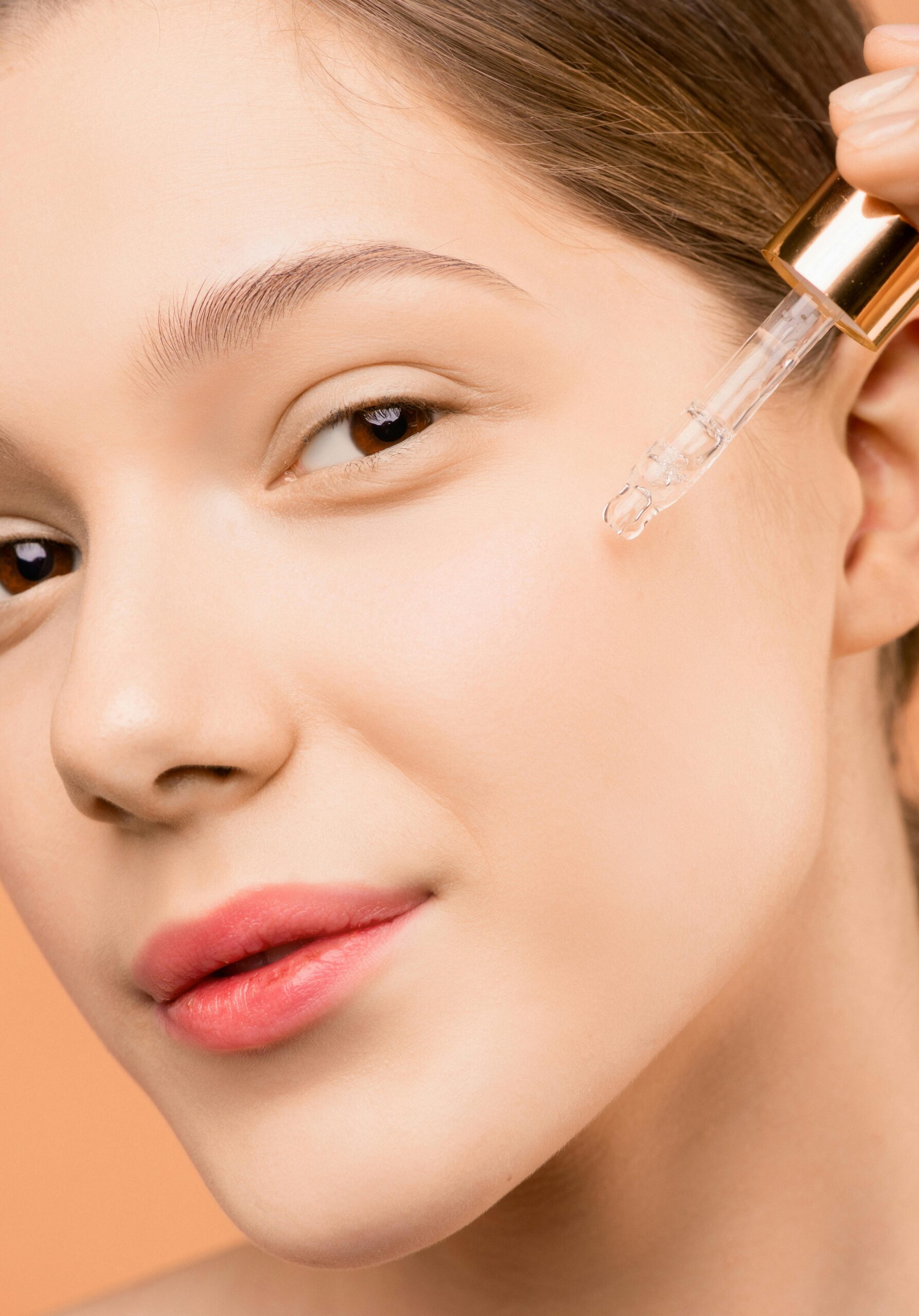 a girl is applying Vanilla Oil on face